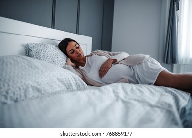 Pregnant Woman Lying On The Bed