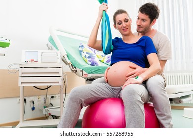 Pregnant Woman And Man In Delivery Room Of Hospital