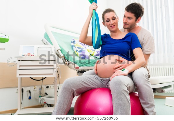 Pregnant woman\
and man in delivery room of\
hospital