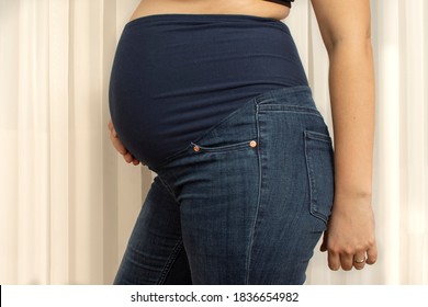 Pregnant Woman With Maternity Pants With Hight Waist. Jeans For Big Tummy. Side View