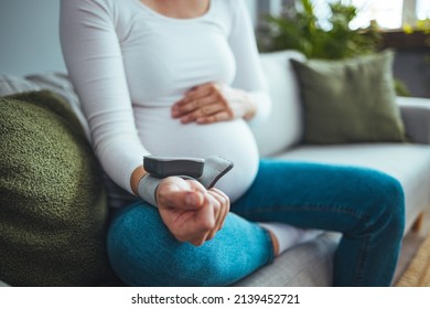 Pregnant Woman Measuring Blood Pressure, Health Check Of Expecting Mom. She Checking Blood Pressure At Home. High Pressure Problem During Pregnancy Concept.