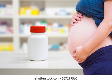 Pregnant Woman With Medicine In The Pharmacy Store, Drug Use In Pregnancy Concept