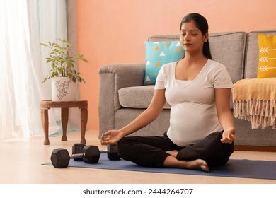 Pregnant woman meditating at home - Powered by Shutterstock