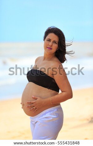 Pregnant woman on the beach 