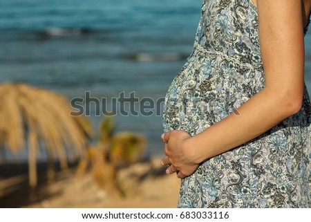 a Pregnant woman on the beach
