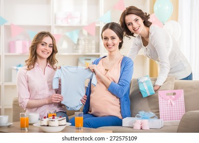 Pregnant Woman Is Open A New Gift At Baby Shower.
