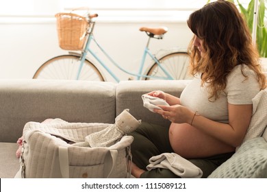 Pregnant Woman Packing Maternity Bag For Hospital Labor