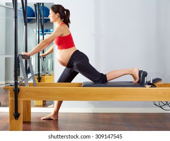 Pregnant Woman Pilates Reformer Cadillac Exercise Workout At Gym