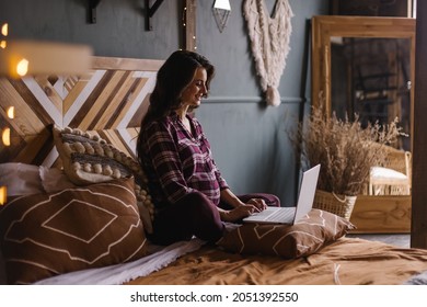 Pregnant Woman In Plaid Shirt At Home With Laptop. Online Shopping. Search For Thanksgiving Gifts On Internet. Remote Work During Pregnancy. The Season Is Autumn. Stylish Country Interior. Education