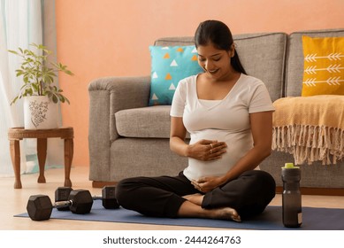 Pregnant woman practising yoga at home - Powered by Shutterstock