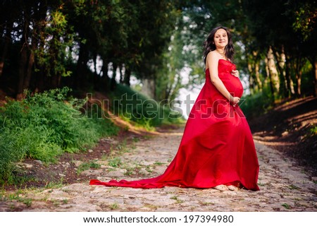 Similar – Melancholic girl with red dress in nature