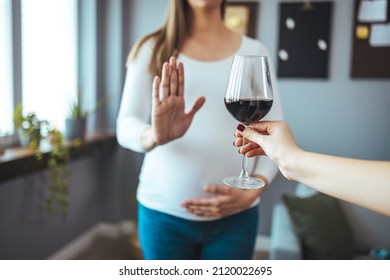 Pregnant Woman Refusing A Glass Of Wine. Alcohol In Pregnancy. Unrecognizable Expectant Lady Gestring Stop To Offered Glass Of Wine