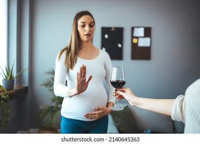 Pregnant Woman Refusing A Glass Of Wine. Alcohol In Pregnancy. Unrecognizable Expectant Lady Gestring Stop To Offered Glass Of Wine