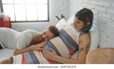 Pregnant woman relaxing on bed while her partner listens to her belly, symbolizing love and family bond in the cozy setting of their home bedroom. - Powered by Shutterstock