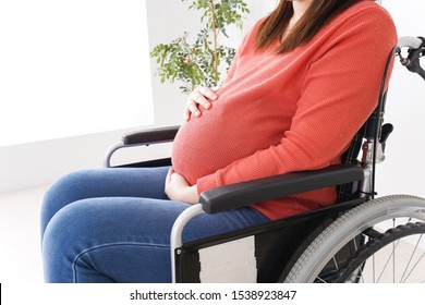 Pregnant woman ride in a wheelchair - Powered by Shutterstock