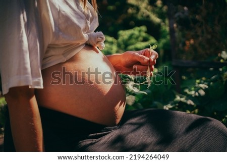 Pregnant woman with seedling is expecting