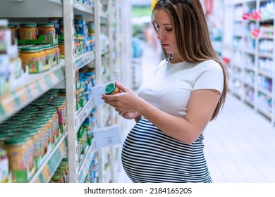 Pregnant Woman Shopping Baby Formula. Young Pregnant Woman Buying Infant Baby Formula Milk On Supermarket Background. Shopping Child Food Supermarket Concept