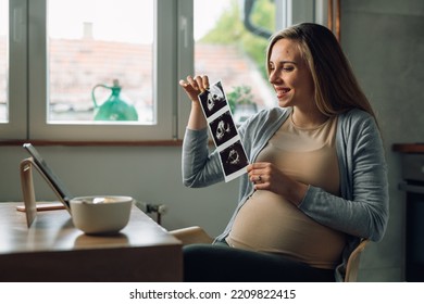 Pregnant Woman Showing Her Baby Ultrasound Photo On A Video Call