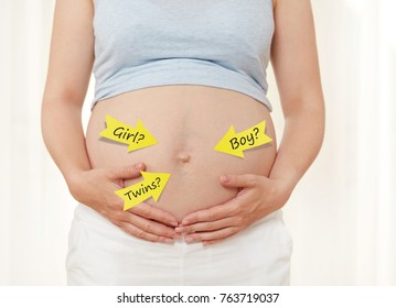 Pregnant woman showing her belly - Shutterstock ID 763719037