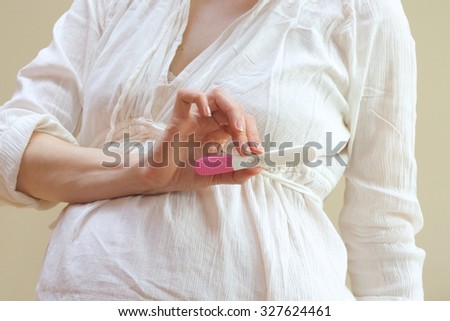 A pregnant woman shows the positive result of a pregnancy test Stock photo © 