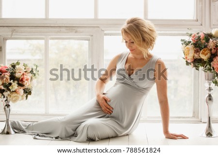 pregnant woman sits on the floor