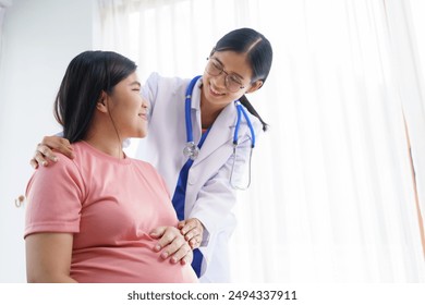 A pregnant woman sits on the sofa in the clinic. The doctor examines her abdomen and reviews the ultrasound results. Offering encouragement, the doctor holds her hand, providing support and care. - Powered by Shutterstock