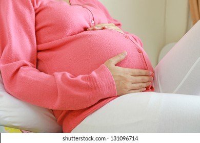 pregnant woman sitting relax on bed