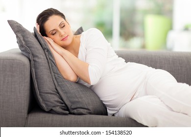 Pregnant Woman Sleeping On A Couch At Home