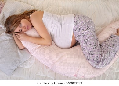 Pregnant Woman Sleeping Peacefully In The Bedroom