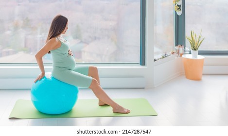 Pregnant woman stability ball prenatal pregnancy home workout stretching muscles for birth using birthing ball for labor position and contractions relief