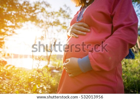 Similar – Foto Bild Schwangere Frau, die ihren Bauch streichelt.