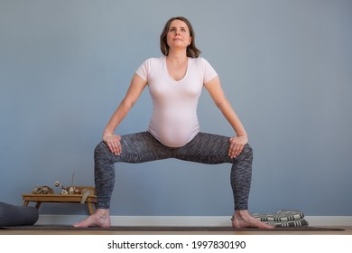 Pregnant Woman Standing In Sumo Squat Exercise, Goddess Pose