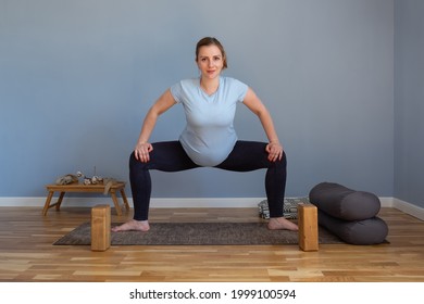 Pregnant Woman Standing In Sumo Squat Exercise, Goddess Pose