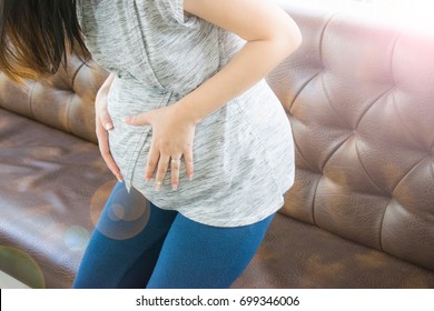 Pregnant Woman With Stomach Ache Holds Her Tummy In Pain. Abdominal Pain During Pregnancy.