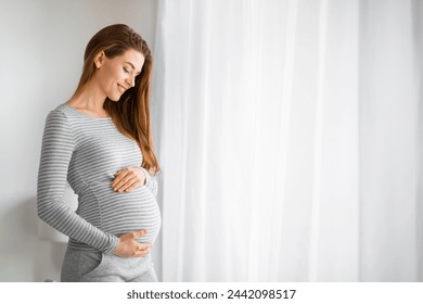 Pregnant woman in stripes smiling with eyes closed, expressing tranquility and happiness - Powered by Shutterstock