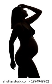 Pregnant woman studio portrait silhouette.