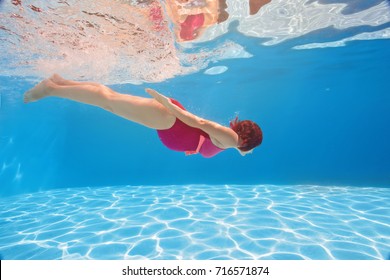 Pregnant Woman Swim, Dive Underwater In Swimming Pool. Aqua Fitness Healthcare Classes For Pregnancy. Aquatic Therapy Workout Is One Of The Safest, Most Efficient Forms Of Exercises.