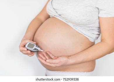 Pregnant Woman Taking Blood Sugar Test