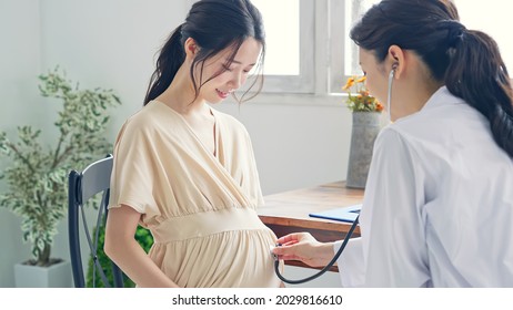 Pregnant woman taking consultation in the clinic.  - Powered by Shutterstock