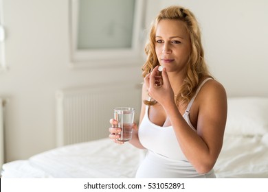 Pregnant Woman Taking Medication Pill