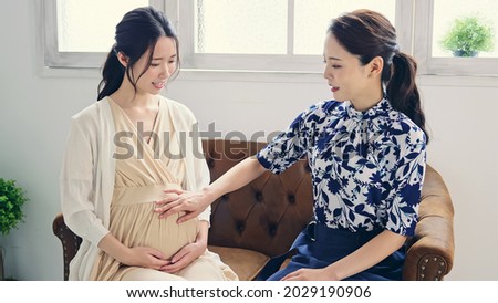 pregnant woman talking in the room. Maternity concept.