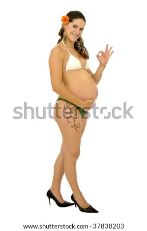 Pregnant woman with tattoo posing in bikini isolated in white