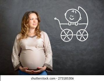 Pregnant Woman Is Thinking About Baby In Pram. Happy Pregnant Woman Imagines Her Future Child. Pensive Person With Dreams On Dark Gray Background. Pregnancy, Expecting, Wish, Want And Waiting Concept