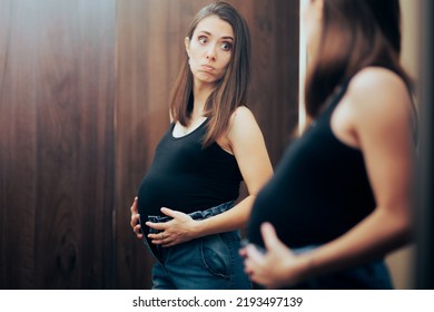 
Pregnant Woman Unable To Close Pants In Need For Maternity Clothes. Stressed Mother To Be Seeing Her Body Image Change In Pregnancy
