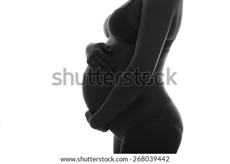 Pregnant woman in underwear cherish her belly. silhouette black and white photo. isolated