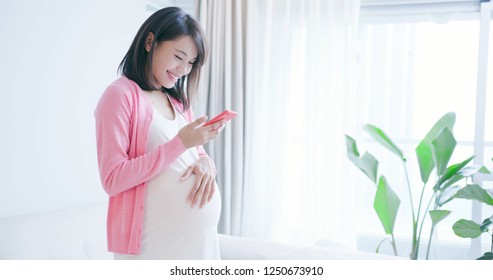 Pregnant Woman Use Smart Phone At Home