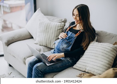 Pregnant Woman Using Computer At Home