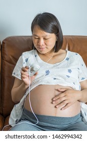 Pregnant Woman Using Fetal Heart Rate Monitor