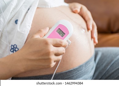 Pregnant Woman Using Fetal Heart Rate Monitor