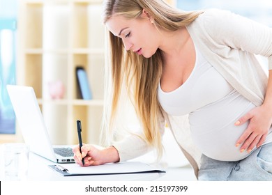 Pregnant woman using laptop 